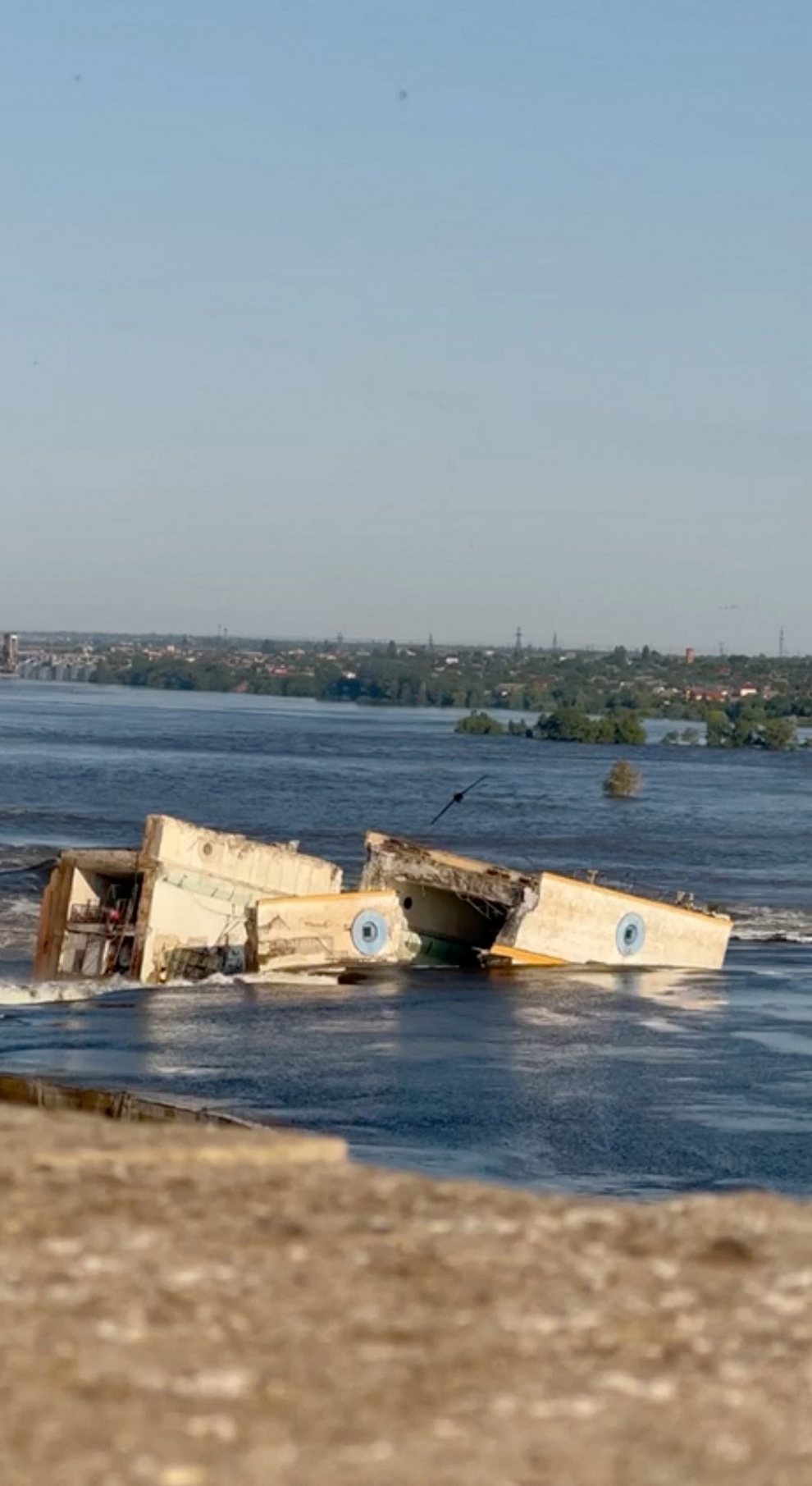 Damaged buildings are seen as the Nova Kakhovka dam was breached in Kherson region, Ukraine June 6, 2023 in this screen grab taken from a video obtained by Reuters/via REUTERS    THIS IMAGE HAS BEEN SUPPLIED BY A THIRD PARTY. NO RESALES. NO ARCHIVES. UKRAINE-CRISIS/BLAST-DAM