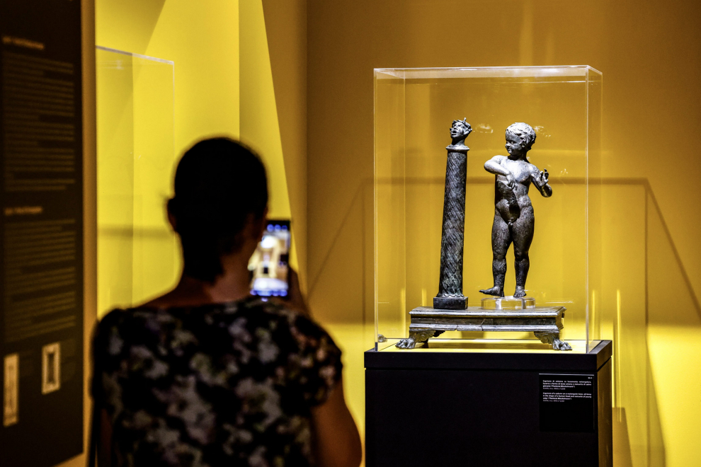 Rome (Italy), 18/06/2023.- A visitor looks at a statue of the lamp-bearing Kouros displayed during a press preview of the exhibition 'New Light from Pompeii to Rome', at the Capitoline Museums, in Rome, Italy 04 July 2023. The exhibition, which offers a journey into the atmospheres and lighting systems of the ancient world through more than 180 original bronze artifacts, will run from 05 July to 08 October 2023. (Italia, Roma) EFE/EPA/FABIO FRUSTACI
 ITALY MUSEUMS EXHIBITION