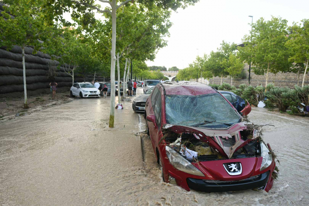Los efectos de la gran tormenta en Zaragoza en el Tercer Cinturón: vehículos amontonados tras haber sido desplazados por el agua.