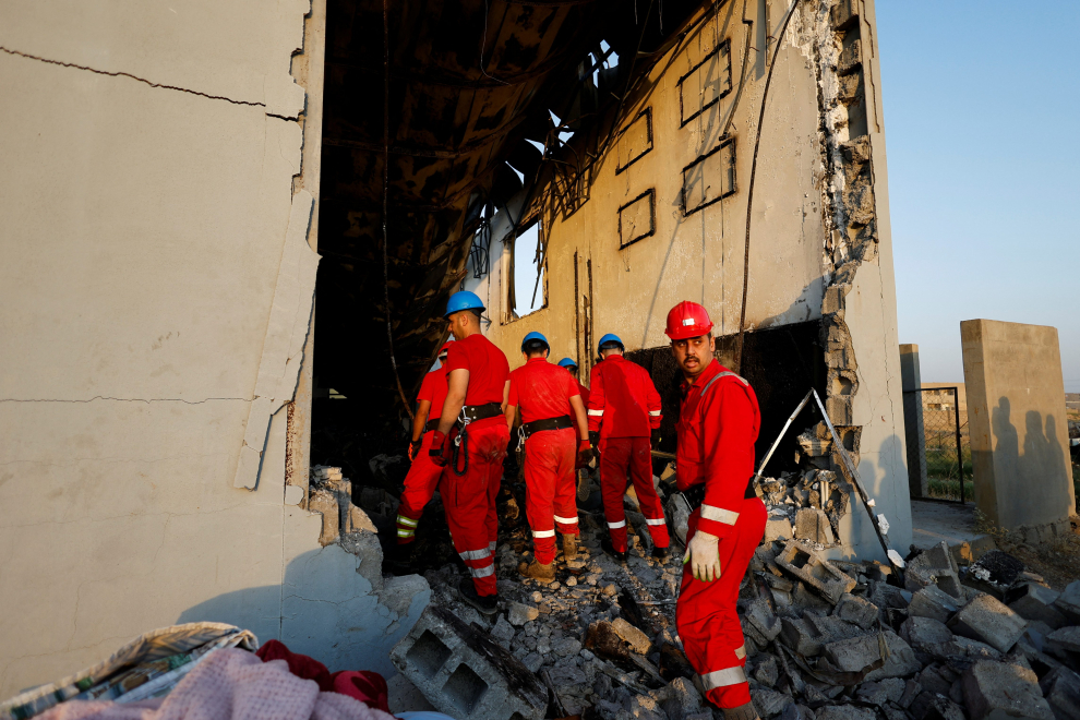 Officials walk at the site following a fatal fire at a wedding celebration, in the district of Hamdaniya in Iraq's Nineveh province, Iraq, September 27, 2023. REUTERS/Khalid Al-Mousily IRAQ-FIRE/