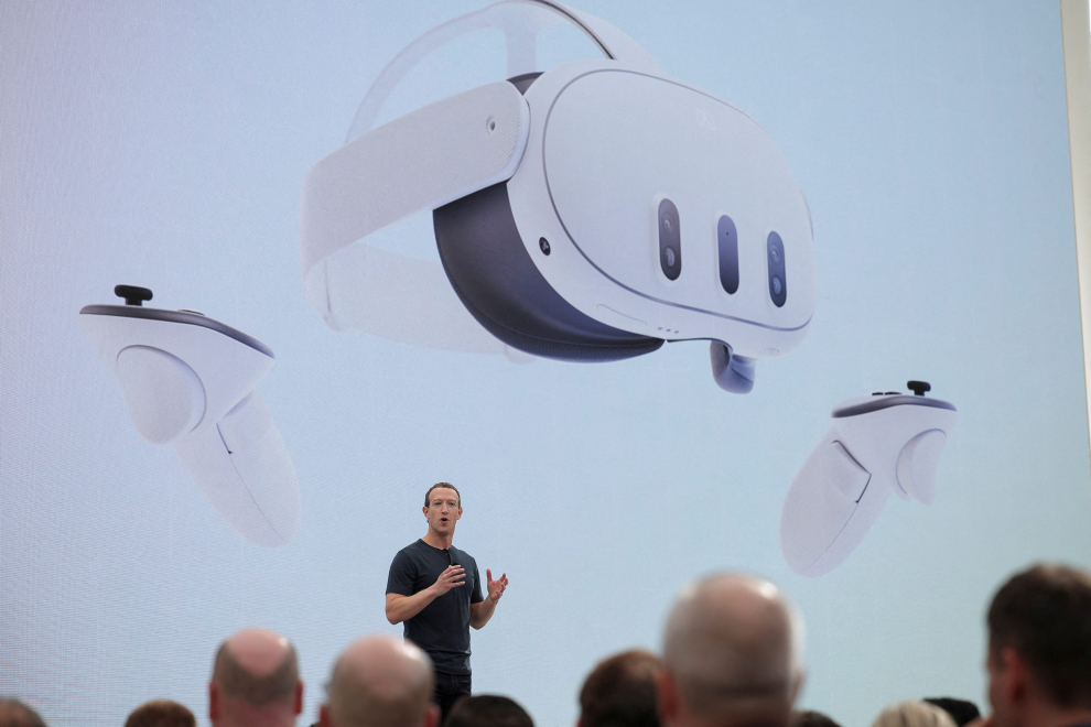 Meta CEO Mark Zuckerberg delivers a speech, as a person wearing a VR headset appears on screen, during the Meta Connect event at the company's headquarters in Menlo Park, California, U.S., September 27, 2023. REUTERS/Carlos Barria META PLATFORMS-VIRTUAL REALITY/