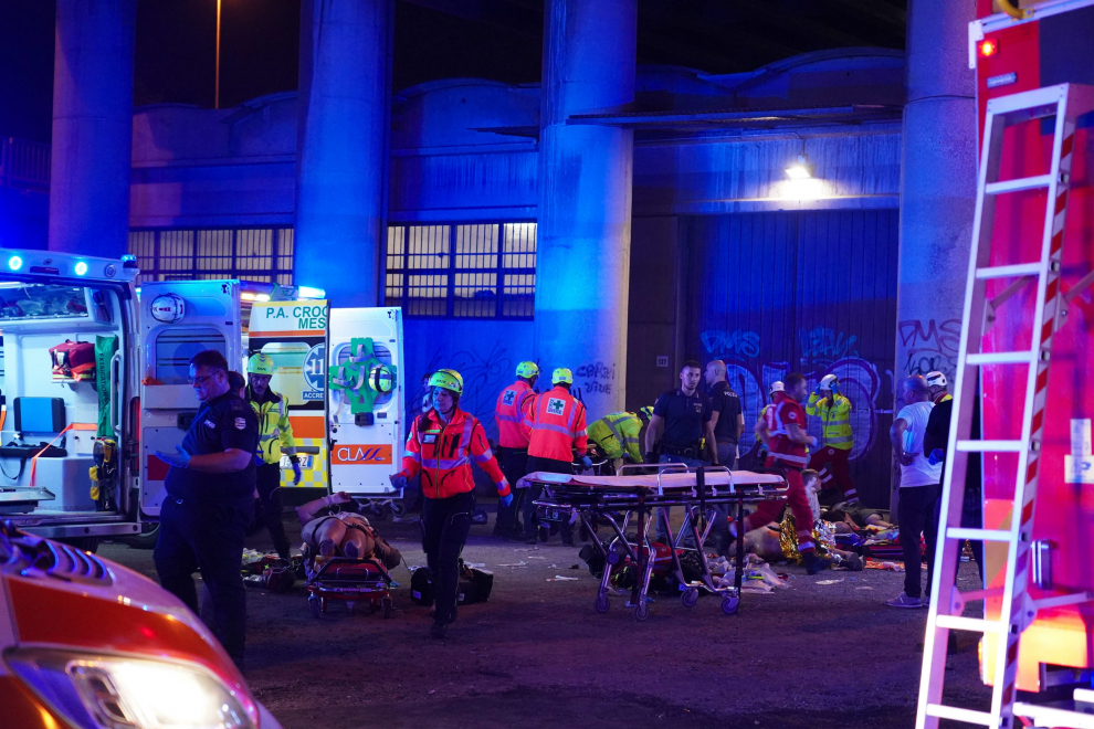 Mestre (Italy), 03/10/2023.- Firefighters work at the site where a passenger bus fell from an overpass ending up on railway tracks in Mestre, near Venice, Italy, late 03 October 2023 (issued 04 October 2023). At least 21 people died in the accident and 15 others were injured. (Italia, Niza, Venecia) EFE/EPA/ANDREA MEROLA
 ITALY ACCIDENT