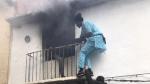 Neighbours save a man from a burning apartment in Denia, Spain December 6, 2019 in this picture obtained from social media. Picture taken December 6, 2019. Roberta Etter/via REUTERS THIS IMAGE HAS BEEN SUPPLIED BY A THIRD PARTY. MANDATORY CREDIT. [[[REUTERS VOCENTO]]]