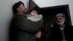 Hamid Safi cries as he holds baby Sohail Ahmadi in Kabul