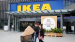 Customers walk by a placard reading "Act Now" as they leave the IKEA store in Kaarst near Duesseldorf, Germany, April 3, 2019. REUTERS/Wolfgang Rattay [[[REUTERS VOCENTO]]] IKEA-SUSTAINABILITY/CITIES
