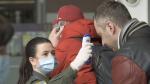 Passengers arriving at airport in Lviv, Ukraine, get their temperatures checked for coronavirus screening