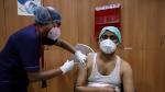 FILE PHOTO: A healthcare worker receives a dose of COVISHIELD at a hospital in Kolkata