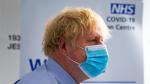 Britain's Prime Minister Boris Johnson visits a vaccination centre at the StoneX Stadium in London