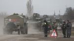 Russian Army military vehicles drive along a street in Armyansk