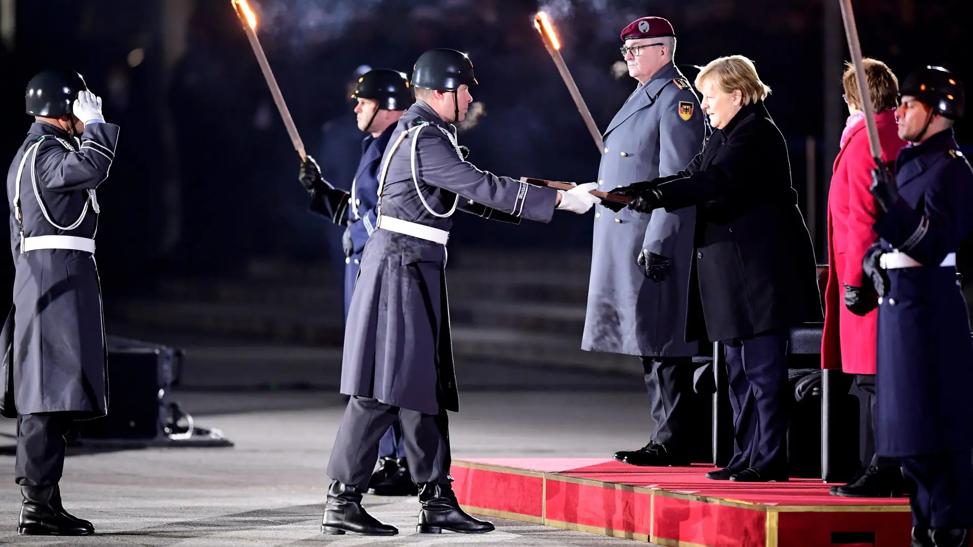 German Chancellor Angela Merkel reacts as she departs from the defence ministry after the Grand Tattoo (Grosser Zapfenstreich), a ceremonial send-off for her in Berlin, Germany December 2, 2021. Odd Andersen/Pool via REUTERS GERMANY-MERKEL/CEREMONY