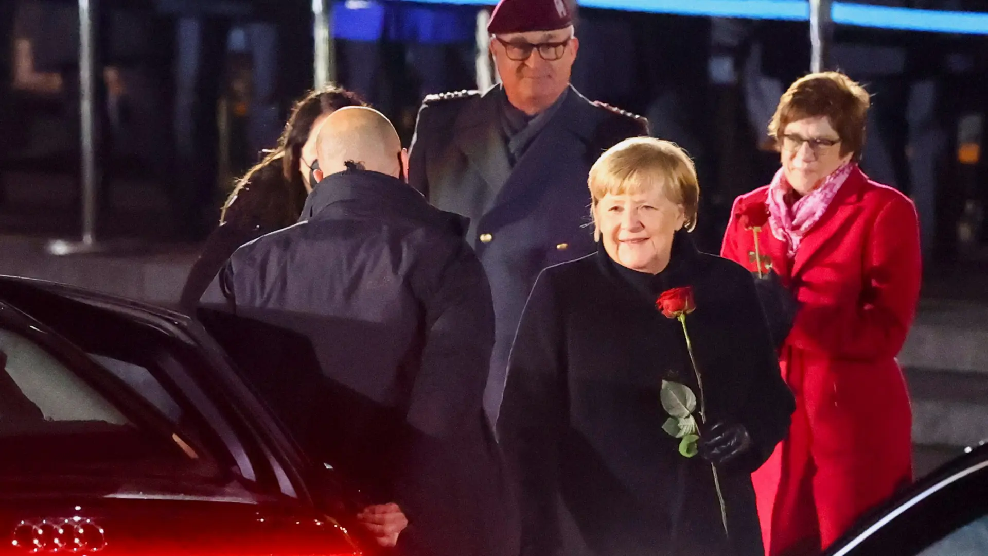 Germany's outgoing Chancellor Angela Merkel holds a rose after attending a Grand Tattoo of the German armed forces Bundeswehr at the Defence Ministry in Berlin, Germany, December 2, 2021. REUTERS/Hannibal Hanschke GERMANY-MERKEL/CEREMONY