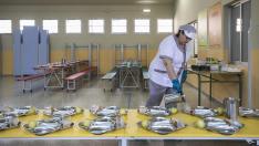 Una trabajadora prepara las mesas del comedor escolar del colegio Emilio Moreno Calvete.