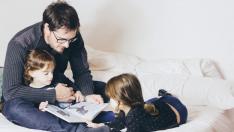 Niños y padre leyendo