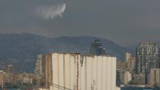 Un helicóptero vierte agua sobre los silos del puerto de Beirut.