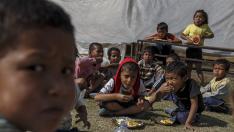 Varios niños de Nepal comiendo en la calle.