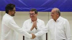 El jefe negociador de las FARC, Iván Márquez, y el del Gobierno de Colombia, Humberto de la Calle, se estrechan la mano tras el acuerdo.