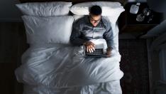 Man on bed using his laptop