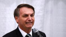 Brazilian President Jair Bolsonaro smiles as he speaks during a meeting with the Brazilian community at The Miami Dade College Auditorium, in Miami