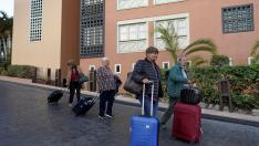 Varios turistas abandonan el hotel H10 Costa Adeje Palace de Tenerife en el que estaban confinados por el coronavirus.