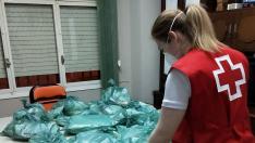 Cruz Roja recoge bolsas y guía a los vecinos sobre cómo hacer mascarillas.