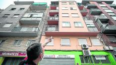 José A. Otín, delante de su taller, señala la ventana del tercer piso desde la que cayó el joven.