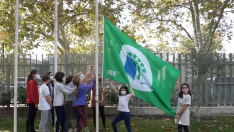 Los alumnos izan la bandera que les acredita como Eco Escuela