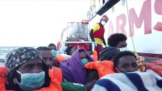 A still image taken from a video shows migrants on board of a dinghy of Spanish search and rescue ship Open Arms en route to quarantine ship 'Adriatico' anchored off the coast of Trapani