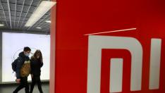 FILE PHOTO: People wearing protective face masks visit Xiaomi brand's store in Kyiv