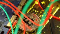 FILE PHOTO: Representation of the Bitcoin virtual currency standing on the PC motherboard is seen in this illustration picture