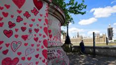 Dedicatorias a las víctimas del covid en el National Covid Memorial Wall en Londres, con el Parlamento al fondo