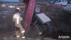 Los bomberos de la DPZ, rescatando al hombre que ha caído en una acequia con su tractor.