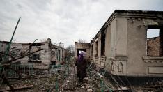 Hanna Chaika, 80, walks by her neighbour's house, that according to her was hit by rockets, amid Russia's invasion of Ukraine, in Ozera, Kyiv region, Ukraine April 23, 2022. REUTERS/Zohra Bensemra UKRAINE-CRISIS/