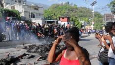 Alleged gang members set on fire by crowd of people, in Port-au-Prince