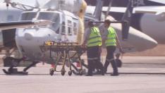 Paramedics push a stretcher following U.S. military aircraft crash in Darwin