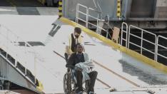 Un hombre ayuda a un inmigrante a embarcar en un ferri en Puerto Estaca, a 29 de octubre de 2023, en El Hierro, Santa Cruz de Tenerife, Tenerife, Canarias (España). En el mes de octubre han llegado a Canarias casi 13.00