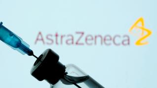 FILE PHOTO: Vial and sryinge are seen in front of displayed AstraZeneca logo