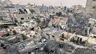 La gente busca entre los escombros de los edificios dañados tras un ataque aéreo israelí contra casas palestinas, en medio del conflicto en curso entre Israel y el grupo islamista palestino Hamas, en Rafah