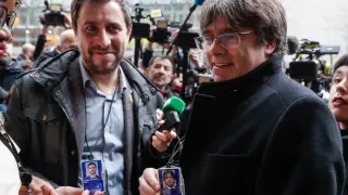 Puigdemont y Comín muestran a la prensa su acreditación provisional como eurodiputados.