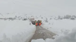 Los servicios de mantenimiento de carreteras retiran una máquina quitanieves atascada en la nieve.