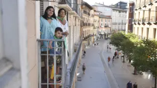 María Rosa del Valle, junto a dos de sus nietos, en el balcón de su casa con vistas al Coso Alto.