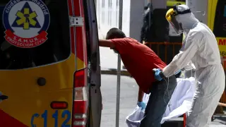 A health worker wearing personal protective equipment, arrives at the emergency unit at 12 de Octubre hospital in Madrid