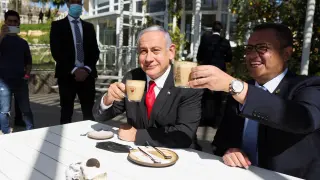 Israeli Prime Minister Benjamin Netanyahu drinks coffee with Mayor of Jerusalem, Moshe Leon, as they sit at a cafe while Israel further eases coronavirus disease (COVID-19) restrictions in Jerusalem