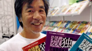 FILE PHOTO: 'Father of Sudoku' Maki Kaji holds copies of the latest sudoku puzzles at the Book Expo, in New York