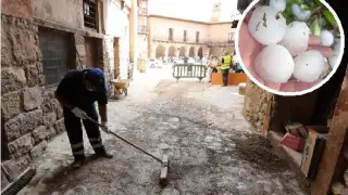 Operarios del Ayuntamiento de Albarración retiran barro de las calles que dejó la tormenta. Al lado, tamaño del granizo caído en Villel