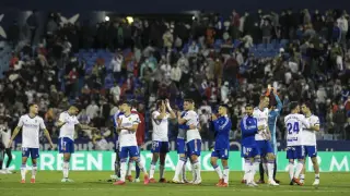 Los jugadores del Real Zaragoza, sumidos en la decepción, en el final del partido ante el Huesca.