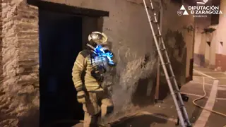 Los bomberos de la DPZ, durante las labores de extinción del fuego de una vivienda abandonada en Tarazona.
