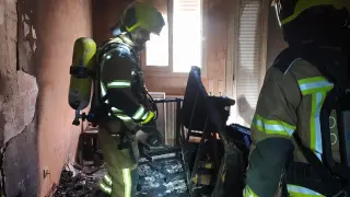Los bomberos, en el interior de la vivienda afectada.