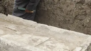 Un trabajador limpia una de los sarcófagos hallados, este sábado.