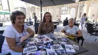 Rosana Franco, Noël Giménez y Mª Ángela Franco, muestran fotos antiguas de la Ofrenda de Flores.