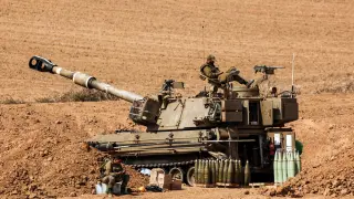 Un soldado israelí, sobre un tanque cerca de la frontera con Gaza